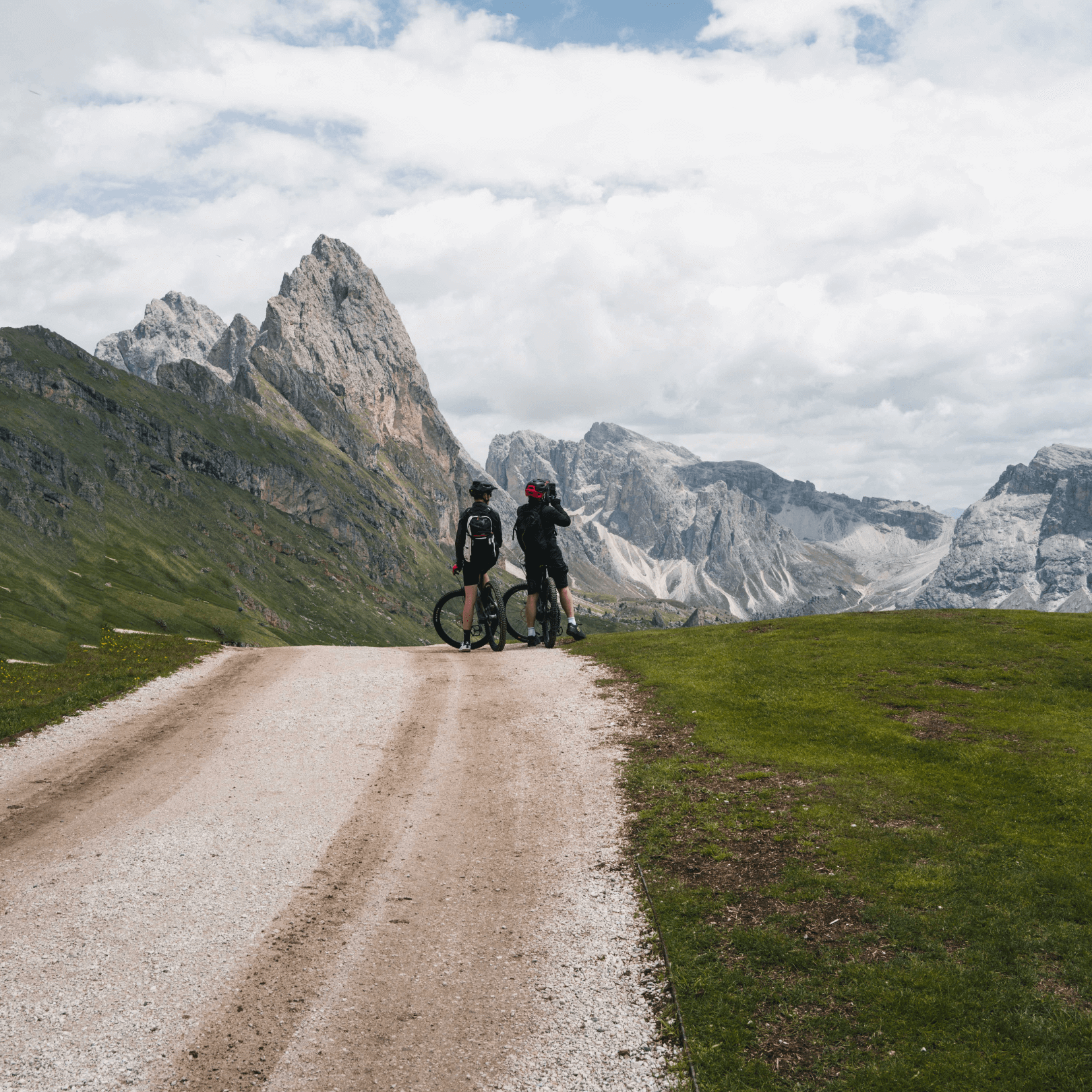 two bikers looking over mountain