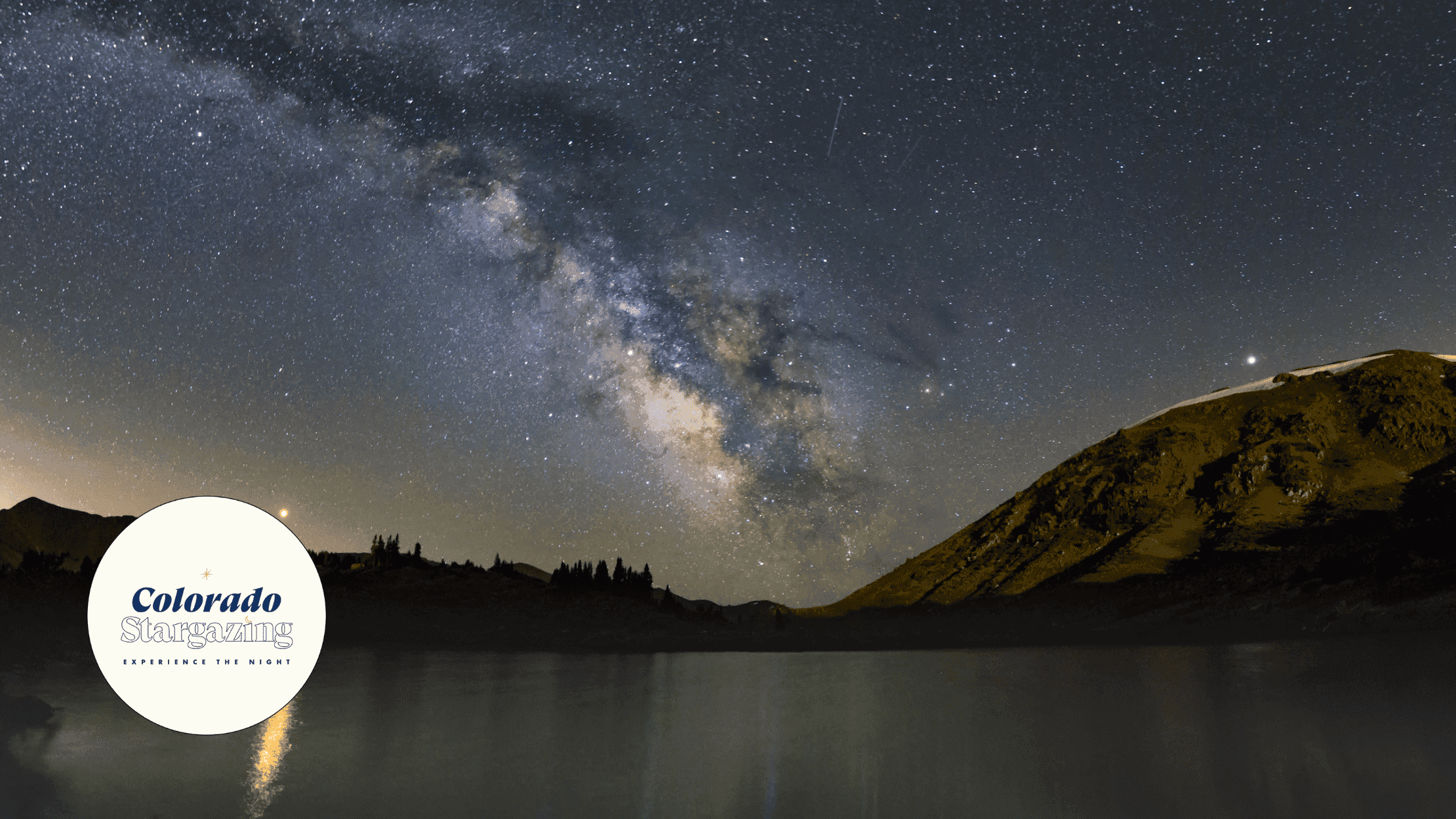 vibrant Milky Way Galaxy at night over lake with Colorado Experience the Night logo