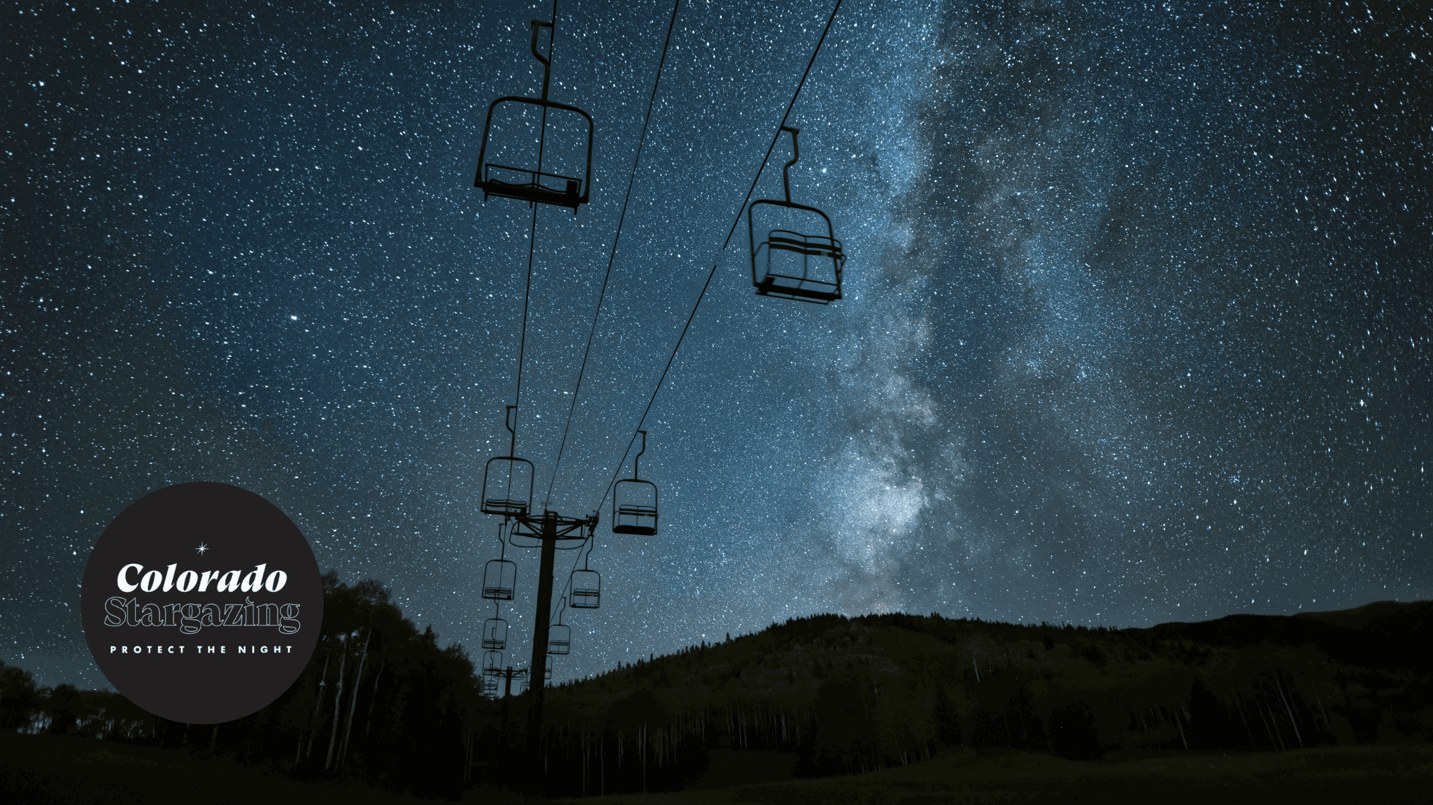 Ski lifts with a vivid, blue stargazing background