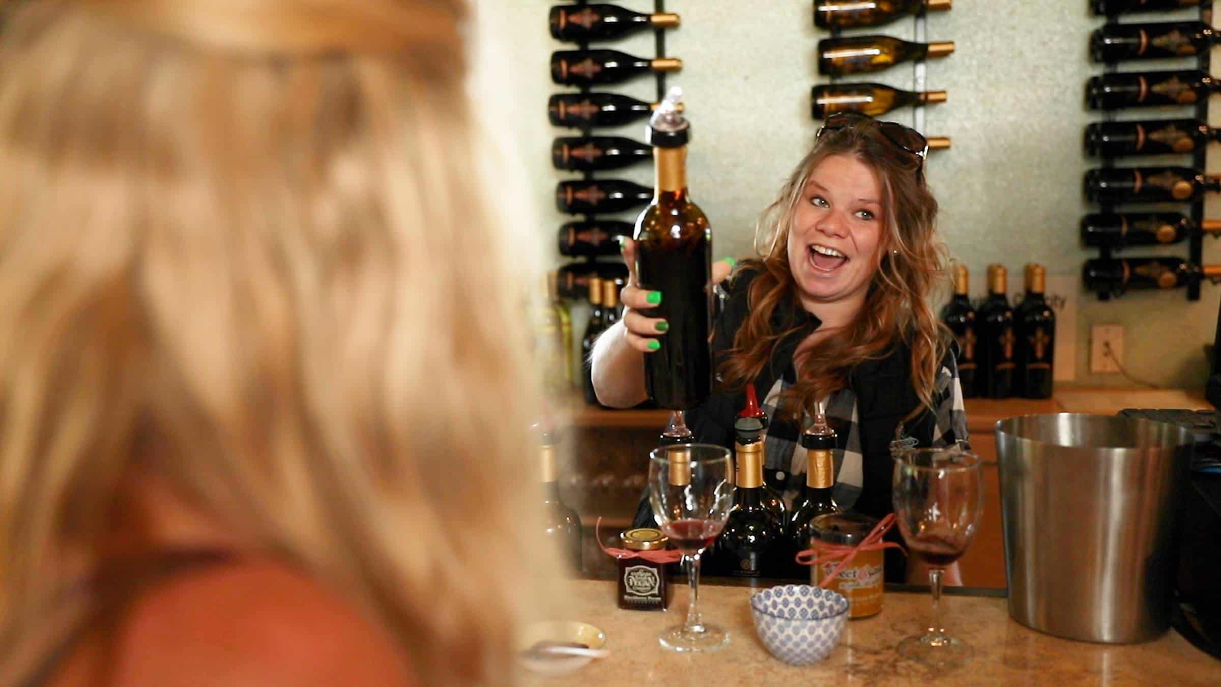 server at Abbey Winery pouring wine for customer